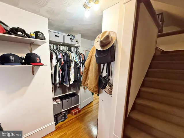 a view of walk in closet with clothes and shoes