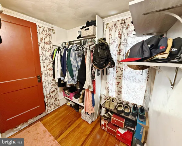 a view of walk in closet with clothes