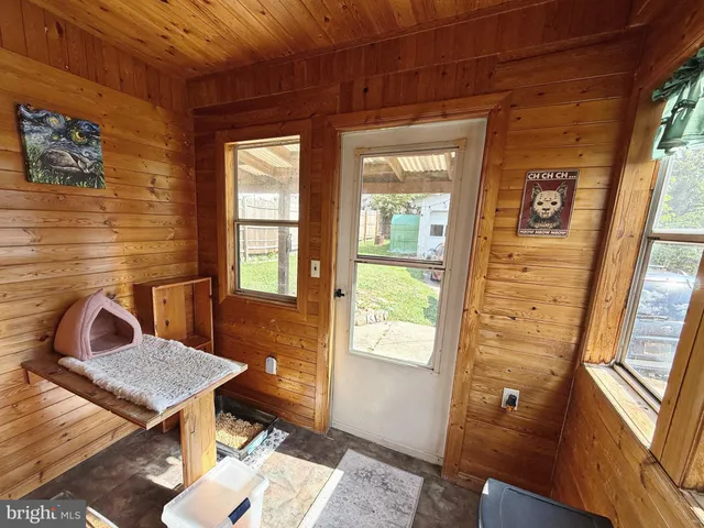 a living room with a table chairs and wooden floor