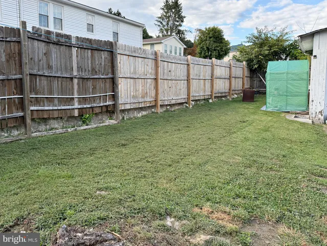 a front view of a house with wooden fence