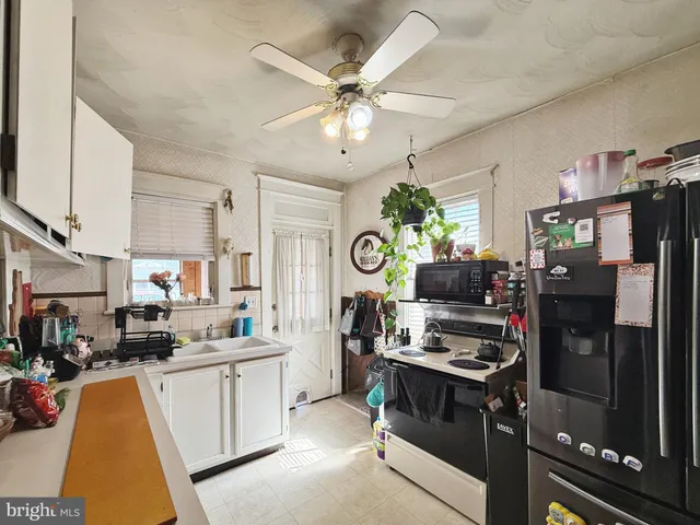 a kitchen with a refrigerator and a stove