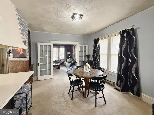 a view of a dining room with furniture and a livingroom