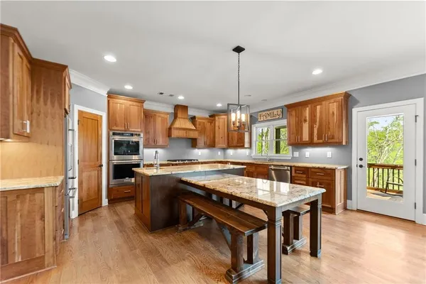 a bedroom with a large bed and a chandelier