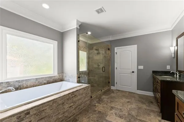 a bathroom with a toilet a sink a mirror and vanity