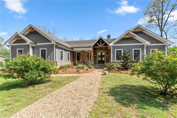 a front view of house with yard and green space