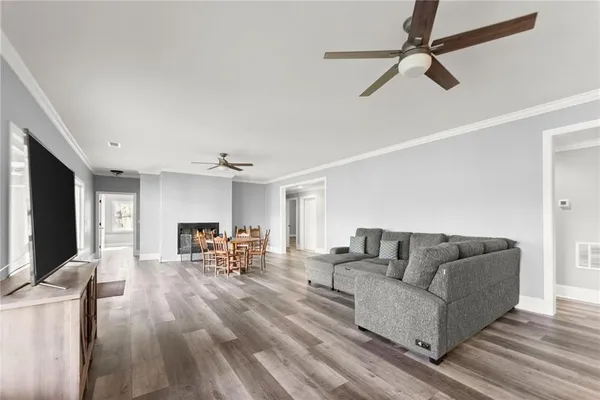 a view of a porch with furniture and wooden floor