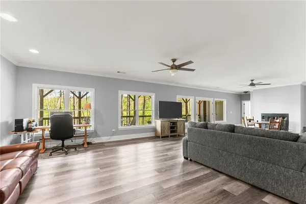 a view of a patio with chairs and wooden floor