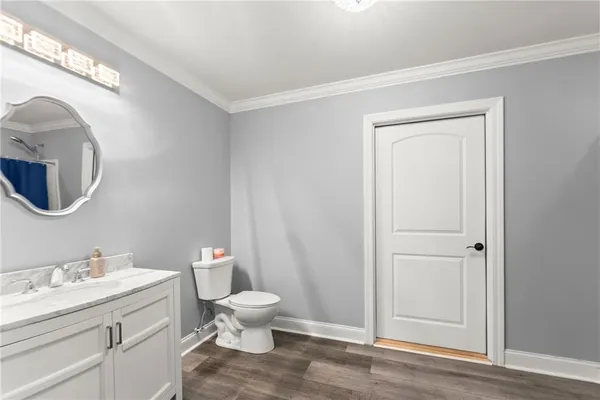 an aerial view of residential houses with outdoor space and trees