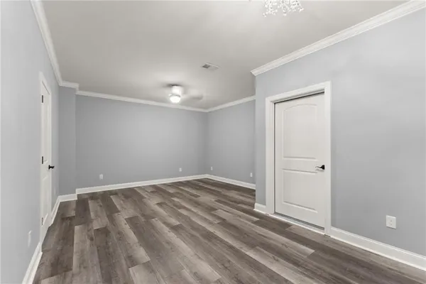 an aerial view of residential houses with outdoor space and trees