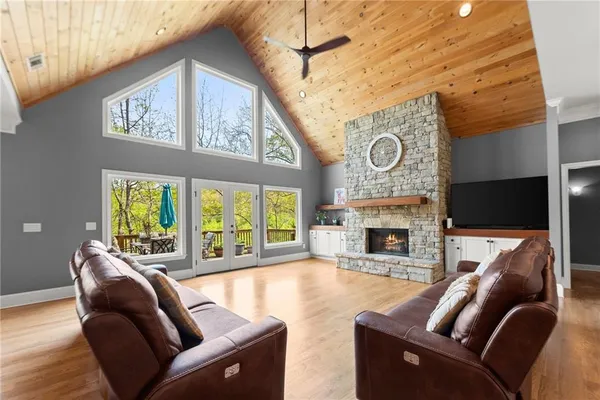 a living room with a bed furniture and a large window