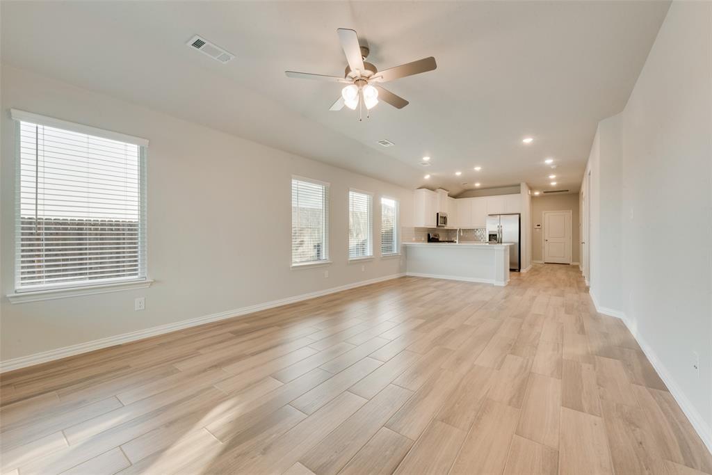 236 Sutter Mill Road Saginaw, TX 76131 - Photo 11 of 20 a view of an empty room with a window and a kitchen
