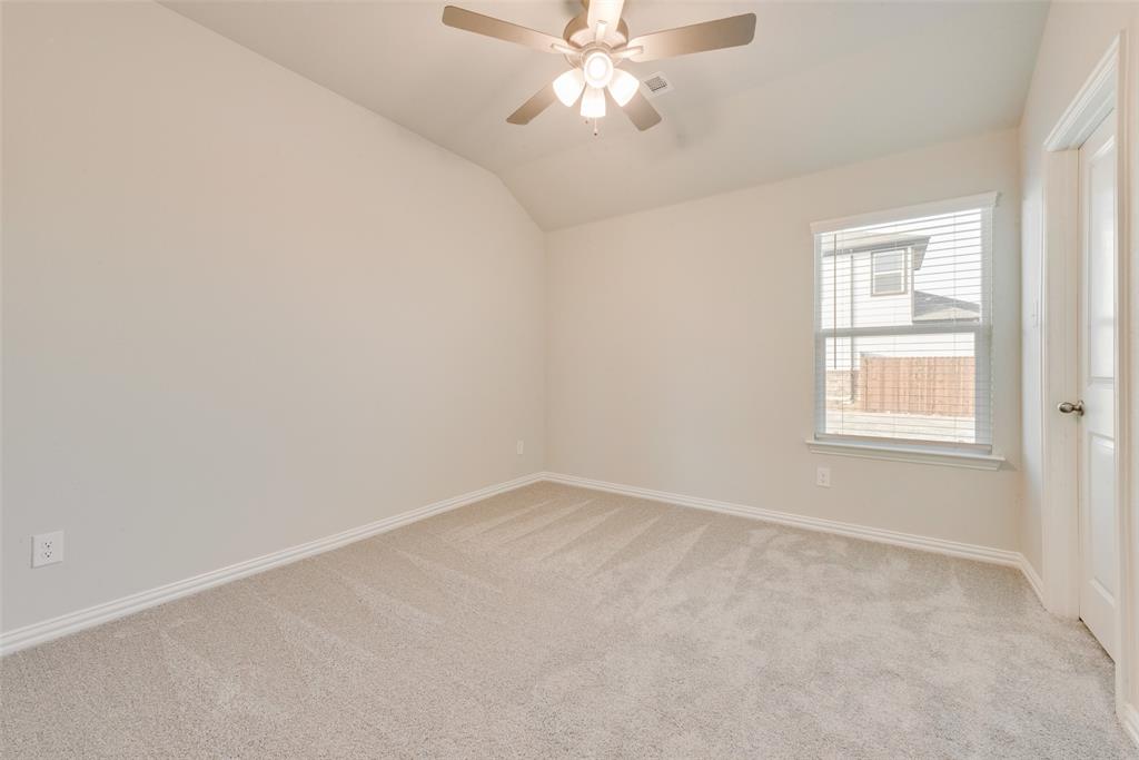 236 Sutter Mill Road Saginaw, TX 76131 - Photo 15 of 20 an empty room with a window and a fan