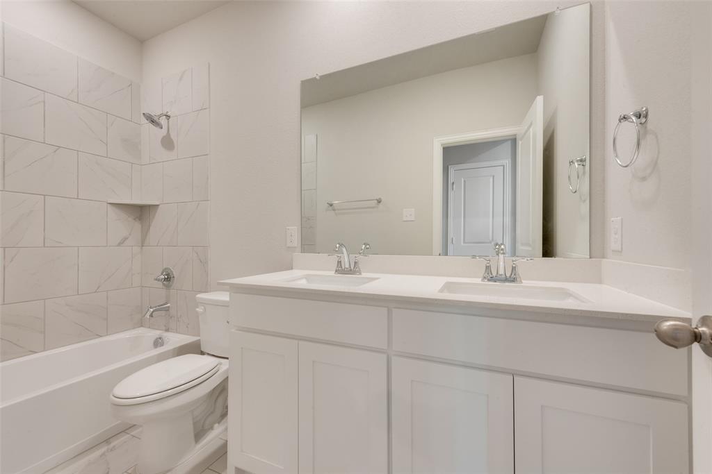 236 Sutter Mill Road Saginaw, TX 76131 - Photo 16 of 20 a bathroom with a sink a toilet and shower