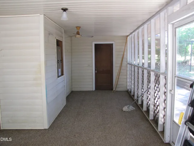 a view of a hallway with wooden shelves