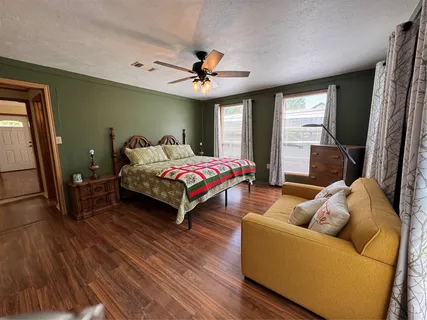 a bedroom with a bed couch and a window