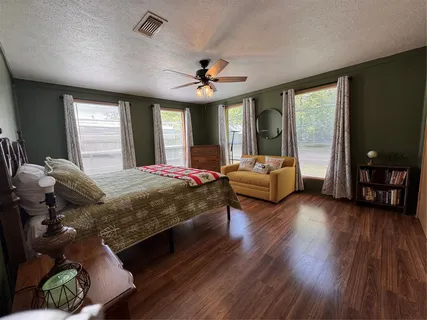 a bedroom with a bed window and couch