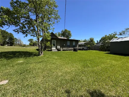 a view of a house with a yard porch and sitting area