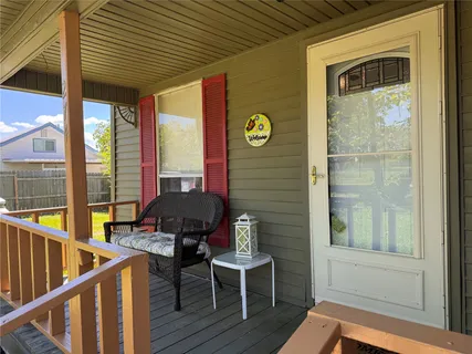 a balcony with table and chairs