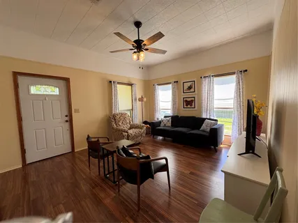 a living room with fireplace furniture and a wooden floor