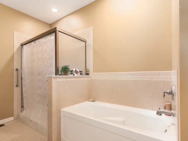 a bathroom with a bathtub and a shower