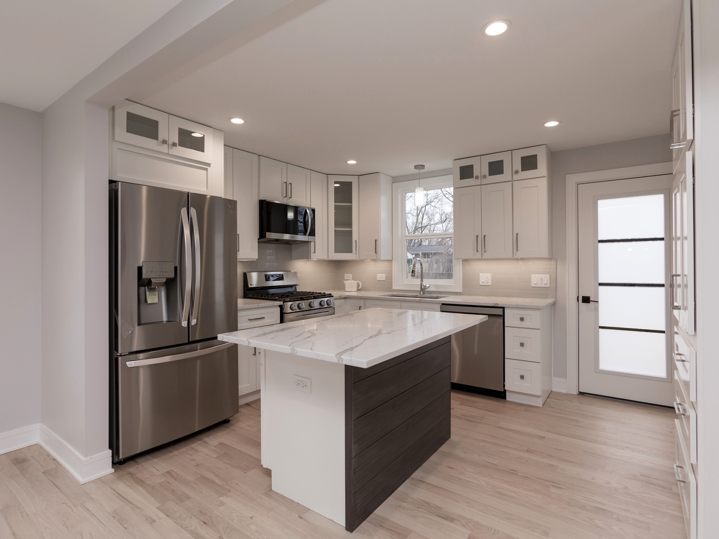 6310 Hilly Way Cary, IL 60013 - Photo 2 of 67 a kitchen with stainless steel appliances granite countertop a refrigerator stove a sink and a oven with wooden floor