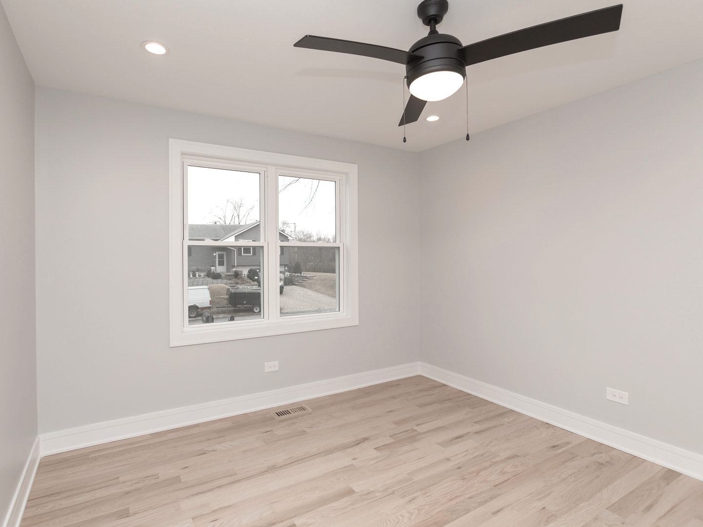 6310 Hilly Way Cary, IL 60013 - Photo 41 of 67 an empty room with wooden floor fan and windows