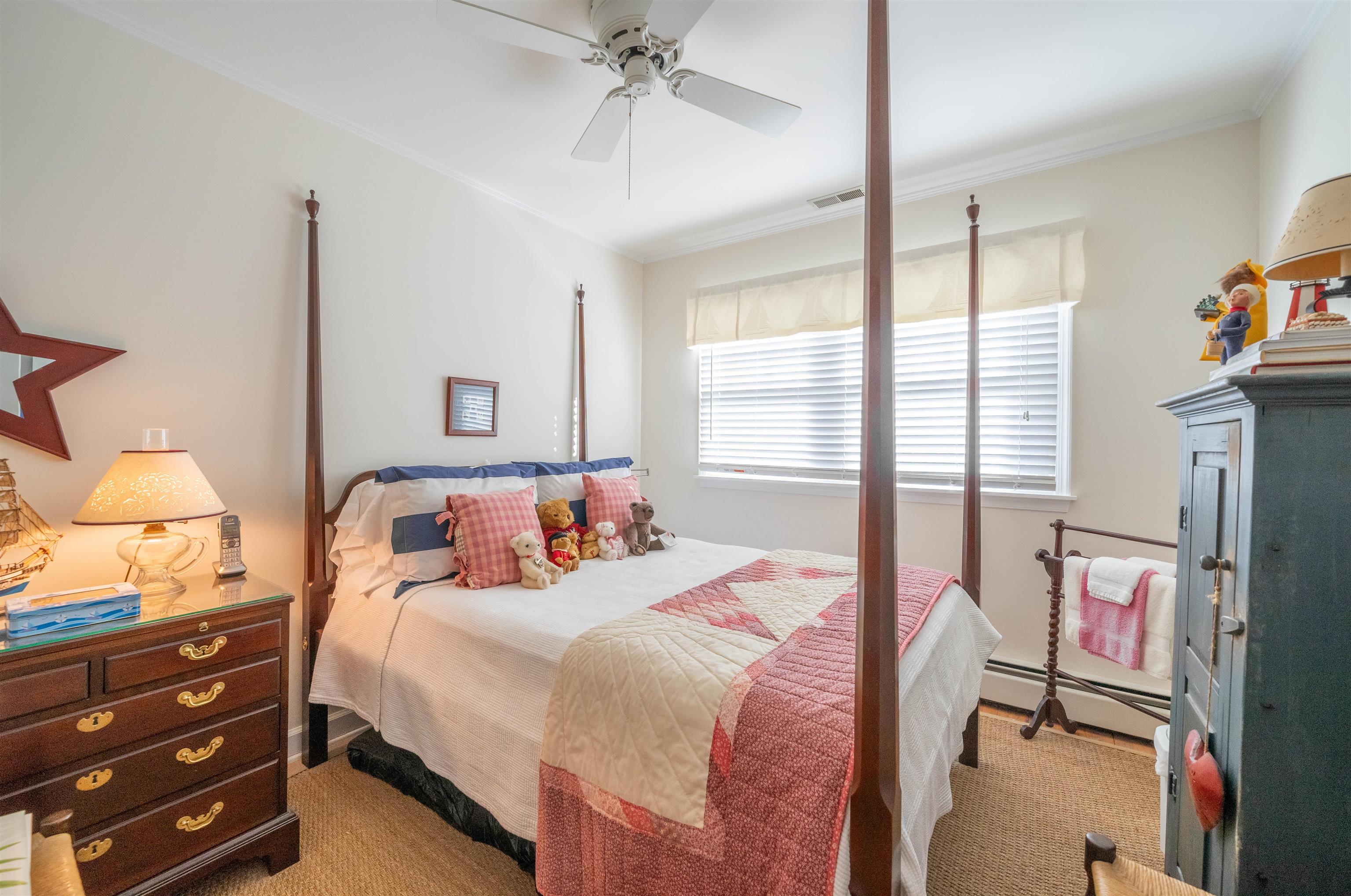 273 60th Street Avalon, NJ 08202 - Photo 14 of 33 a bedroom with a bed and a chandelier