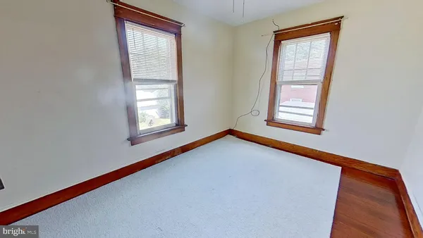 a view of an empty room with windows