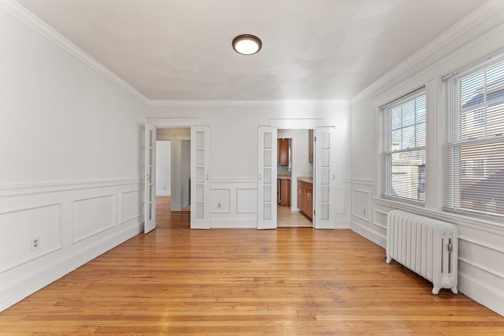 54 Chester Road, Unit 1 Belmont, MA 02478 - Photo 12 of 31 a view of an empty room with wooden floor and a window