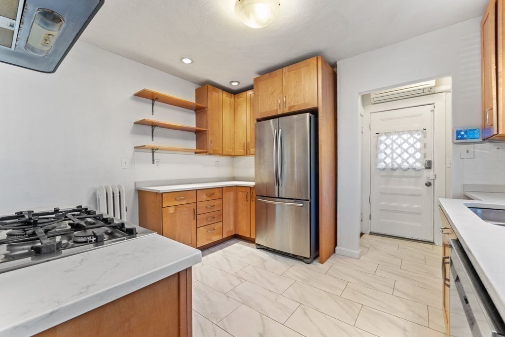 54 Chester Road, Unit 1 Belmont, MA 02478 - Photo 15 of 31 a kitchen with a stove a refrigerator and a cabinets
