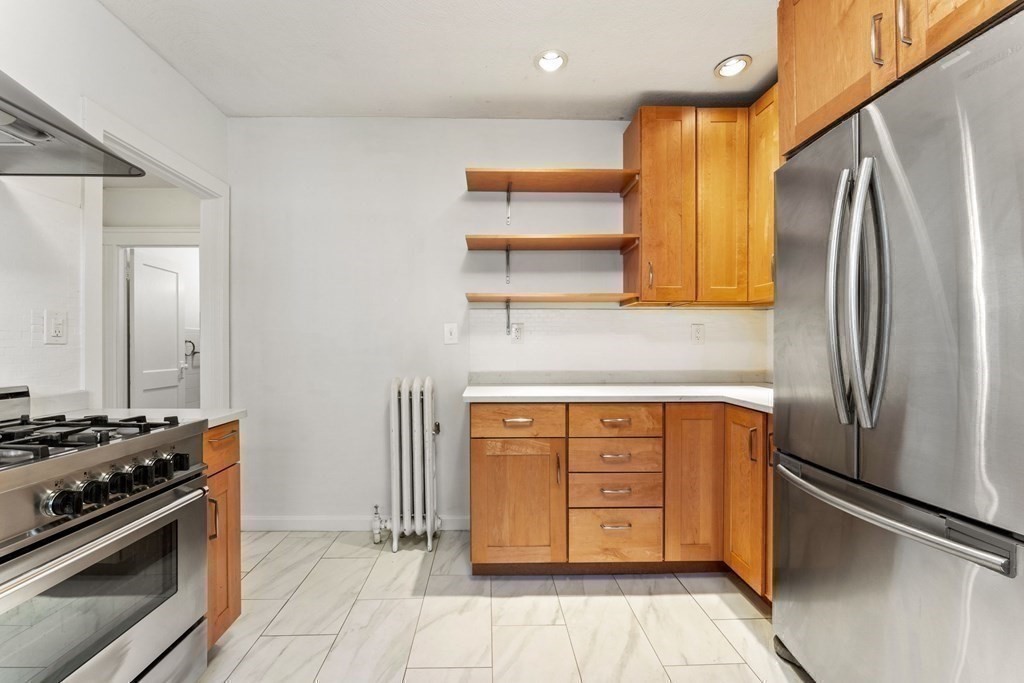 54 Chester Road, Unit 1 Belmont, MA 02478 - Photo 18 of 31 a kitchen with stainless steel appliances granite countertop a refrigerator and a stove