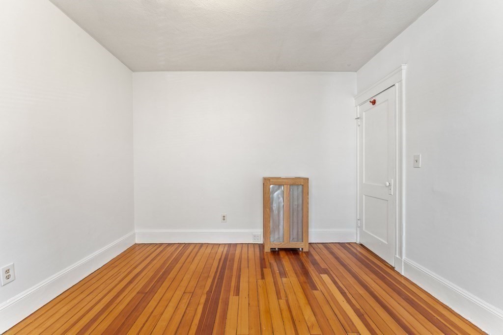 54 Chester Road, Unit 1 Belmont, MA 02478 - Photo 24 of 31 a view of an empty room and wooden floor