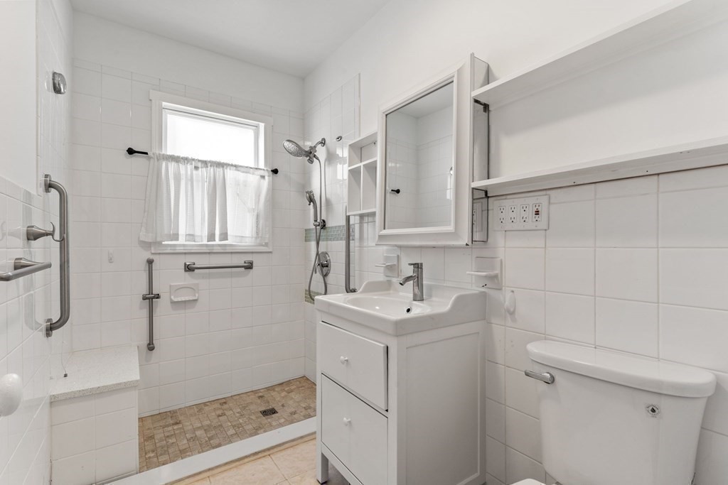 54 Chester Road, Unit 1 Belmont, MA 02478 - Photo 26 of 31 a bathroom with a sink a toilet and shower