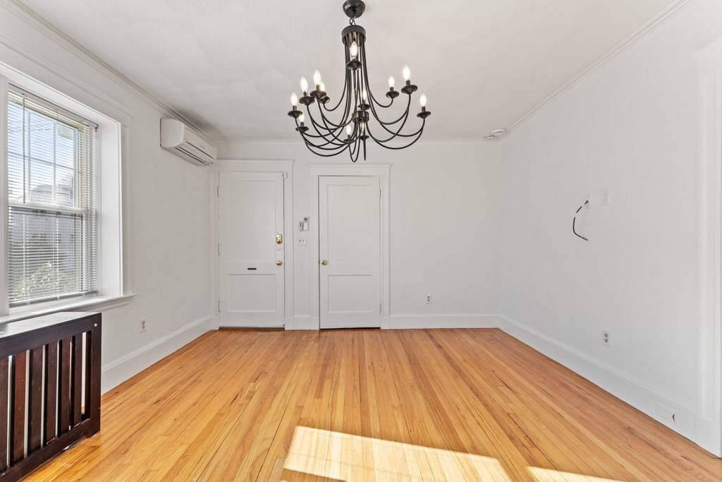 54 Chester Road, Unit 1 Belmont, MA 02478 - Photo 4 of 31 a view of a room with wooden floor and exposed radiator