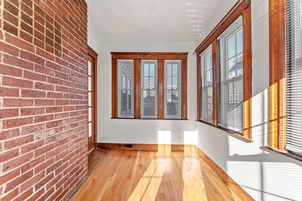 54 Chester Road, Unit 1 Belmont, MA 02478 - Photo 6 of 31 a view of an empty room with wooden floor and a window