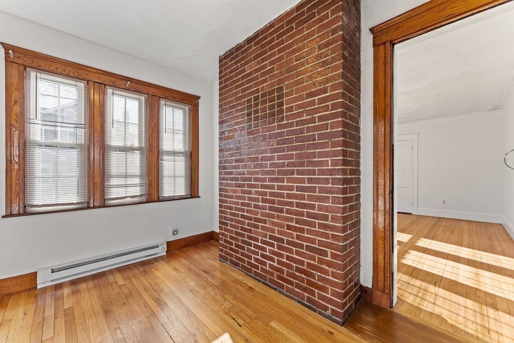 54 Chester Road, Unit 1 Belmont, MA 02478 - Photo 7 of 31 a view of empty room with wooden floor and fan