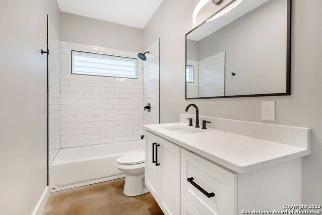 a bathroom with a sink toilet vanity and tub