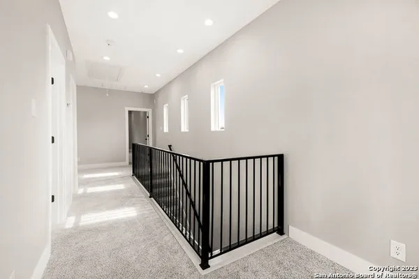 a view of a hallway with wooden floor and entryway
