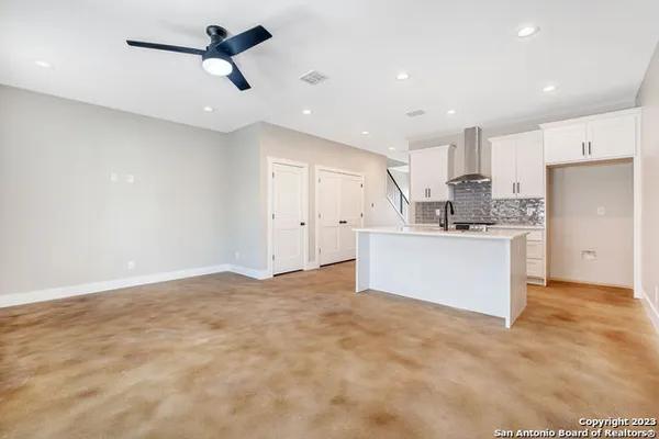 a view of a kitchen with a sink and stainless steel appliances