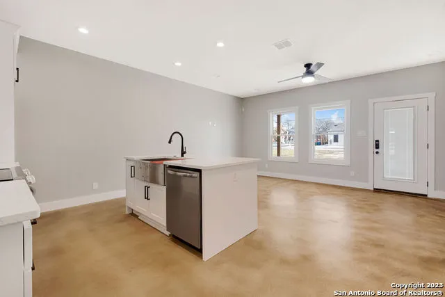 a kitchen with stainless steel appliances granite countertop a stove and a refrigerator