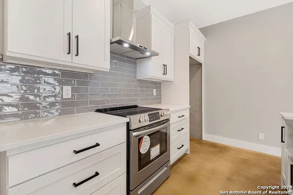 a kitchen with cabinets and a stove