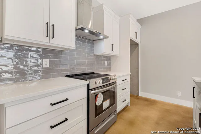 a kitchen with cabinets and a stove