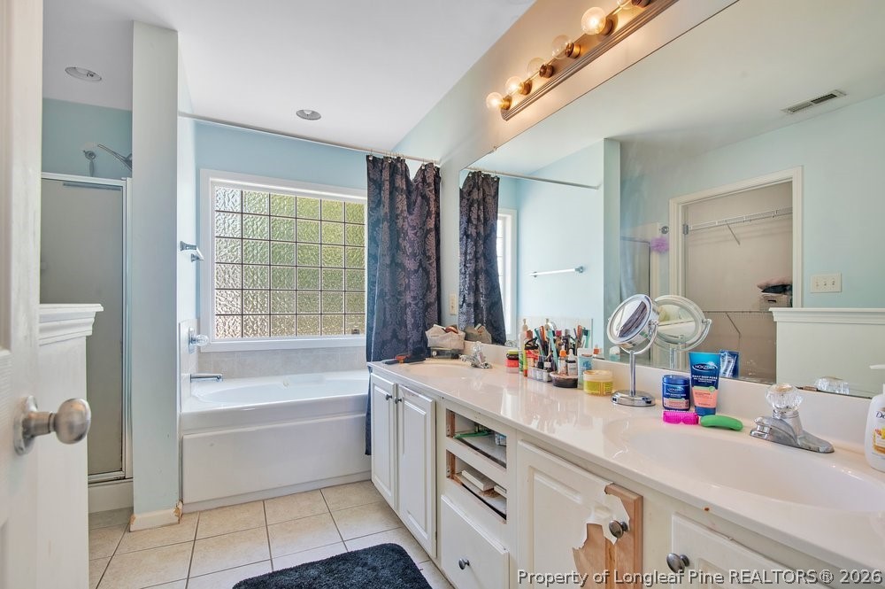 10 Pender Road Spring Lake, NC 28390 - Photo 24 of 35 a bathroom with a tub sink and a mirror