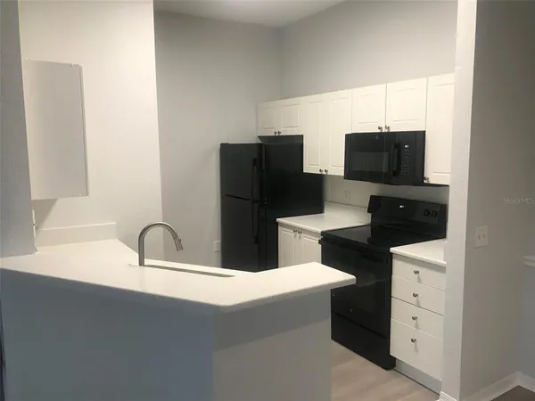 a kitchen with a refrigerator and a sink
