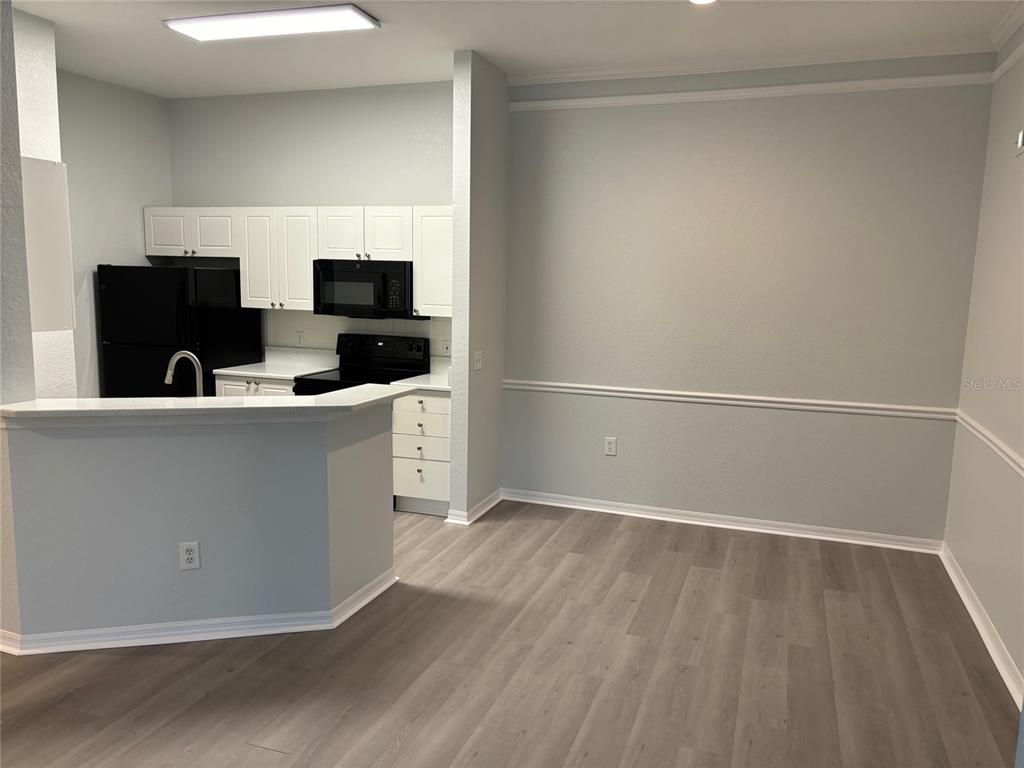 5122 Northridge Road, Unit 306 Sarasota, FL 34238 - Photo 3 of 21 a kitchen with stainless steel appliances a refrigerator and a sink