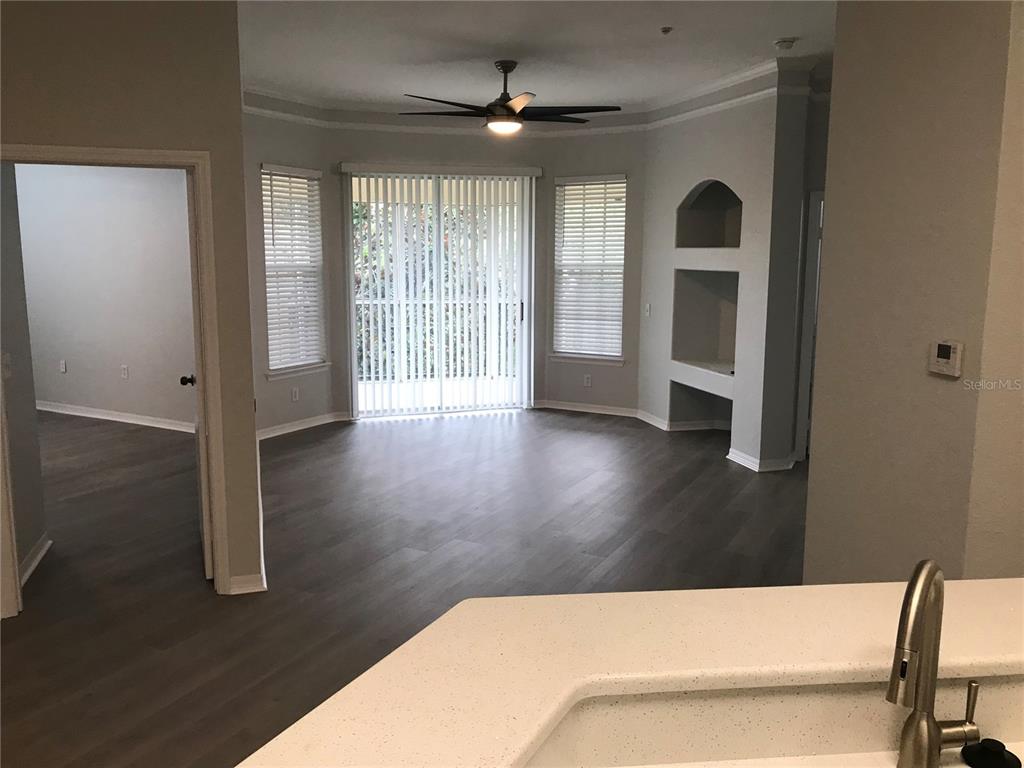 5122 Northridge Road, Unit 306 Sarasota, FL 34238 - Photo 7 of 21 a living room with hardwood floor and a ceiling fan