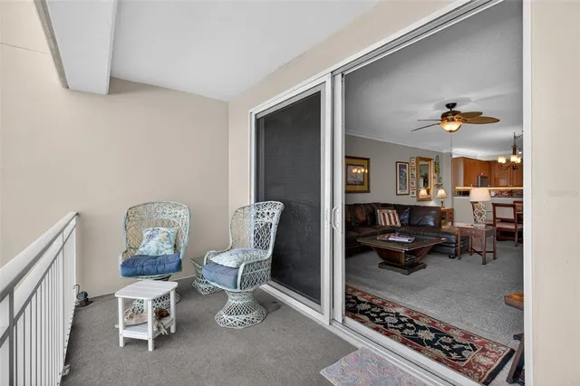a view of a swimming pool with a dining table and chairs