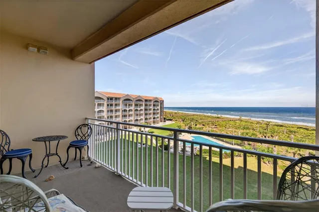 a view of a swimming pool with sitting area and furniture