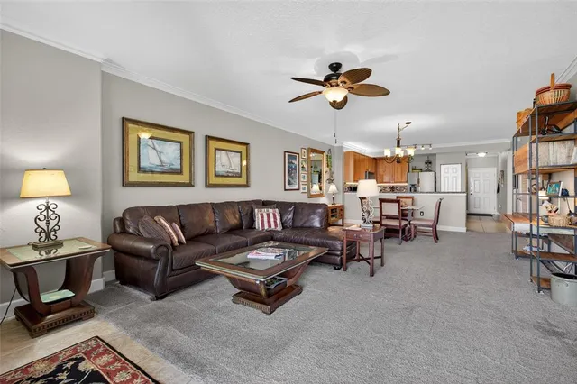 a living room with furniture a flat screen tv and a large window