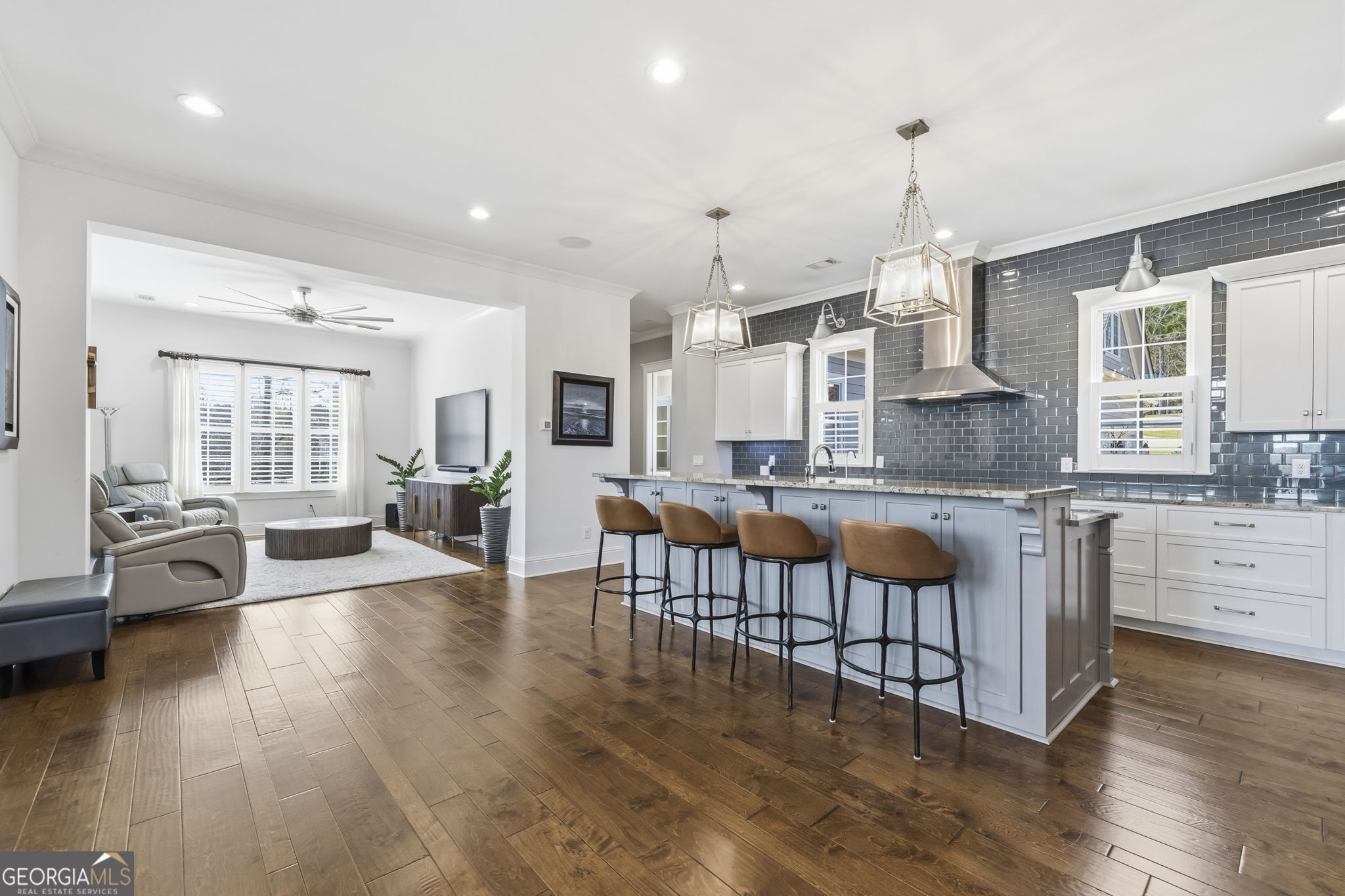 1060 Rdg Grv Court Greensboro, GA 30642 - Photo 18 of 68 an open kitchen with granite countertop a stove and white cabinets with wooden floor